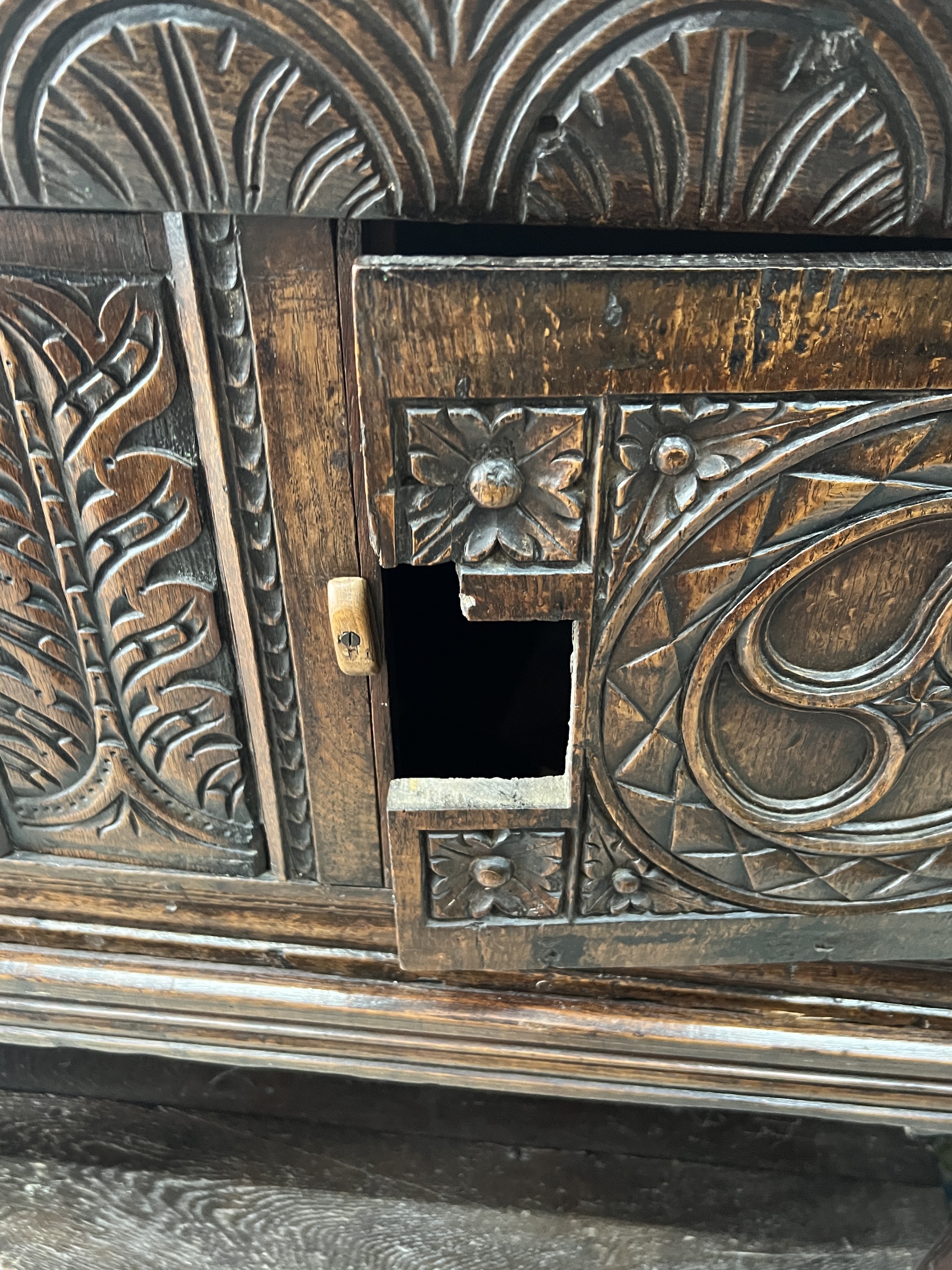 A 17th century and later carved oak potboard cupboard on stand, width 123cm, depth 43cm, height 111cm